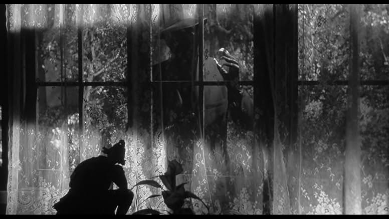 The Bat's claws seen through a window